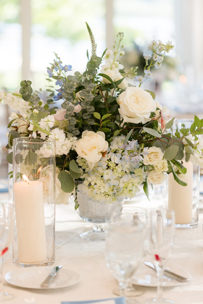 blue, white, and eucalyptus centerpiece with pillar candles | wedding tablescape at Indian Trail Club | Idalia Photography